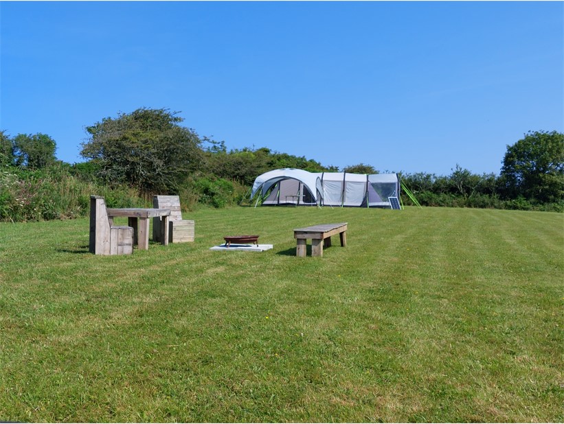 Campsite in Cornwall pitch with tent, seating and firepit